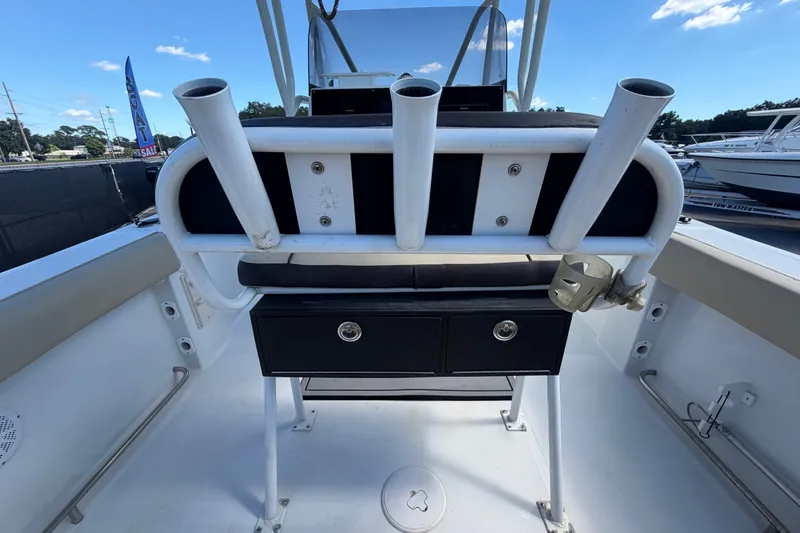 Slide: The Image of 2021 Key Largo 2650WI boat interior with rod holders and storage drawers. - 21
