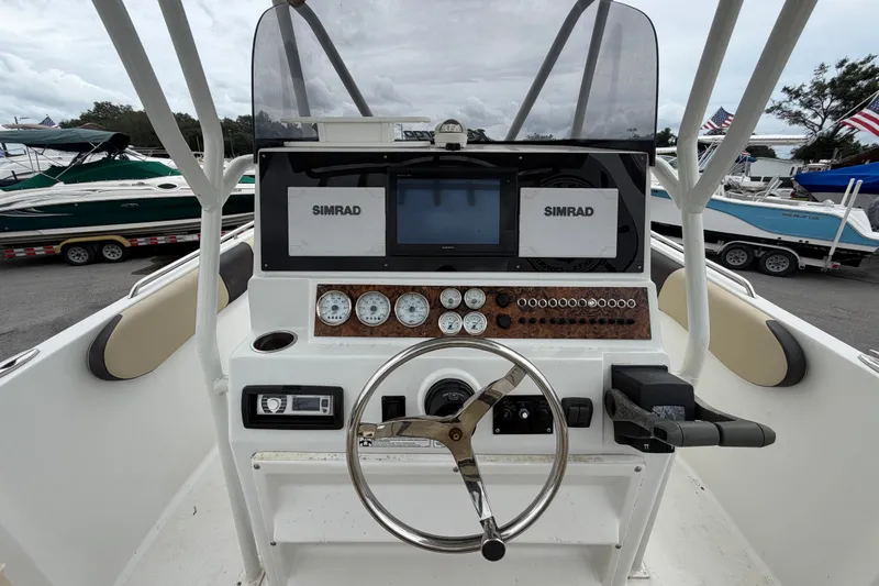Slide: The Image of Key Largo 2650WI 2021 boat dashboard with Simrad navigation system and gauges. - 12