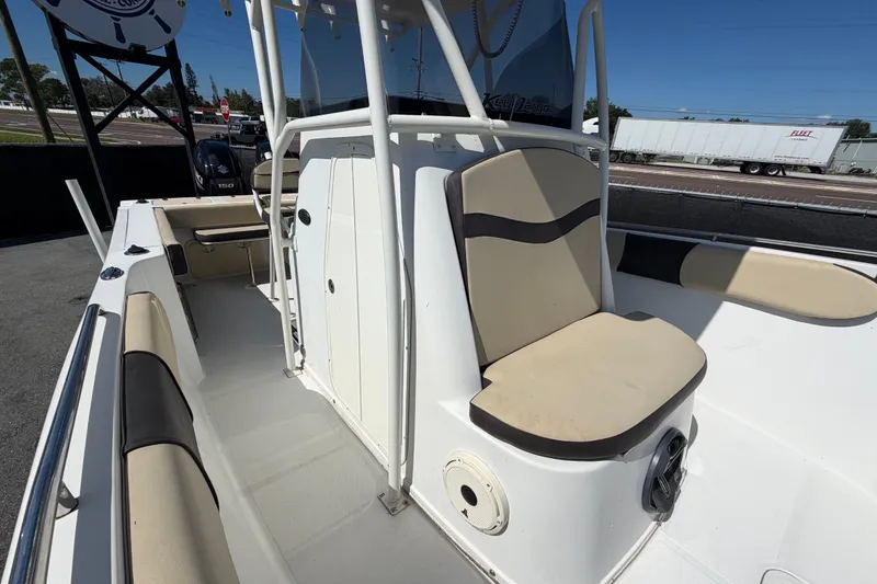 Slide: The Image of 2021 Key Largo 2650WI boat interior with seating and storage compartments. - 61