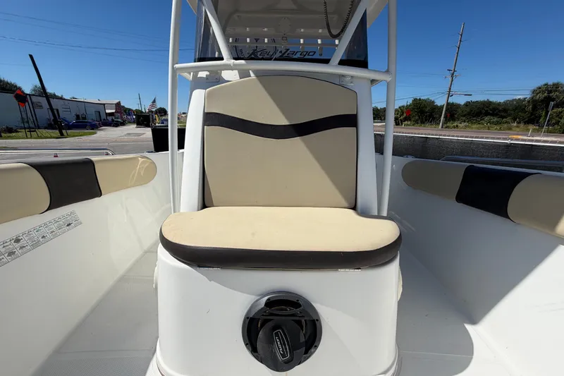 Slide: The Image of 2021 Key Largo 2650WI boat interior with beige seating and console. - 57