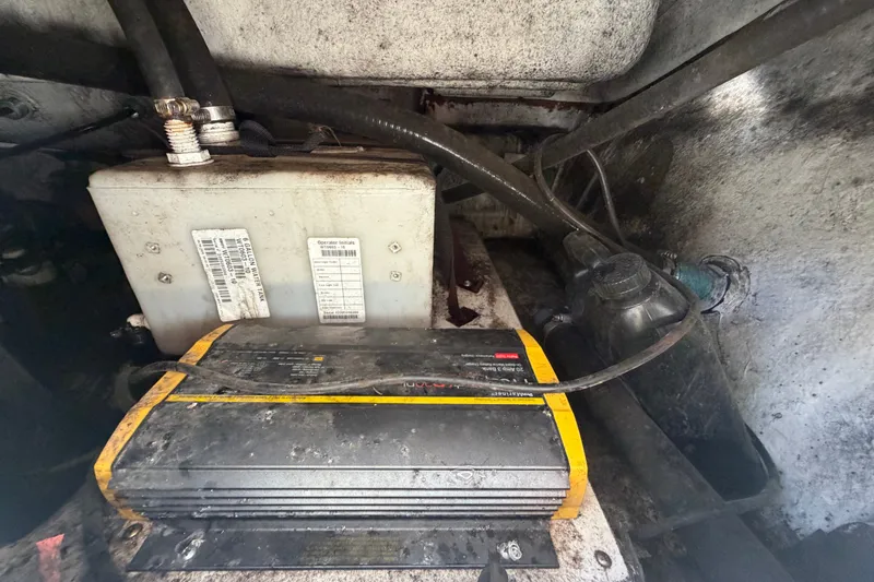 Slide: The Image of Battery and charger setup in a 2021 Key Largo 2650WI boat. - 72