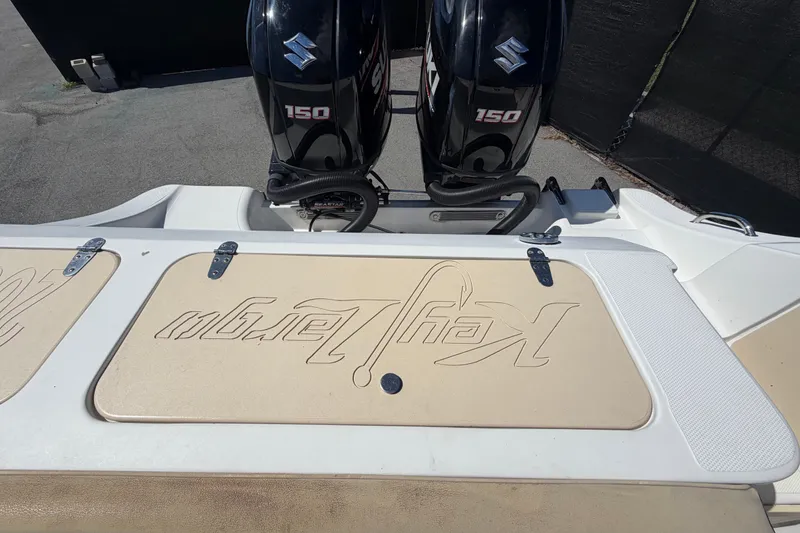 Slide: The Image of 2021 Key Largo 2650WI boat with dual Suzuki 150 engines, rear deck view. - 74