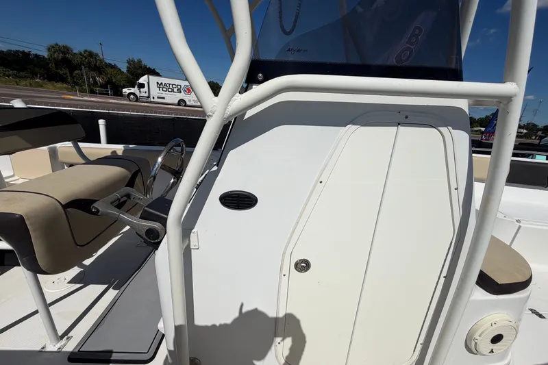 Slide: The Image of 2021 Key Largo 2650WI boat interior with steering wheel and seating. - 62