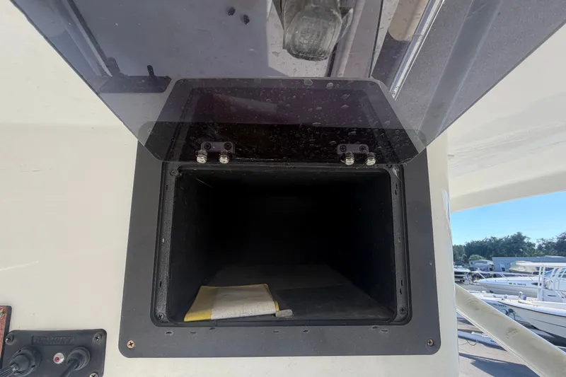 Slide: The Image of Storage compartment on a 2021 Key Largo 2650WI boat, open with visible interior. - 29