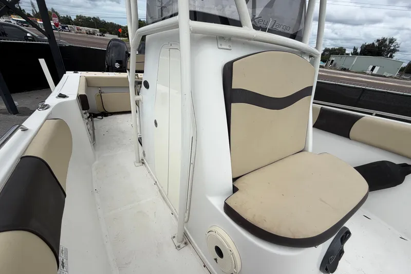 Slide: The Image of 2021 Key Largo 2650WI boat interior with beige and black seating. - 16