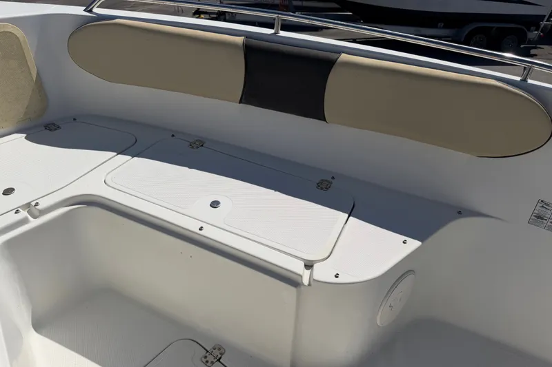 Slide: The Image of 2021 Key Largo 2650WI boat interior seating and storage compartments. - 50
