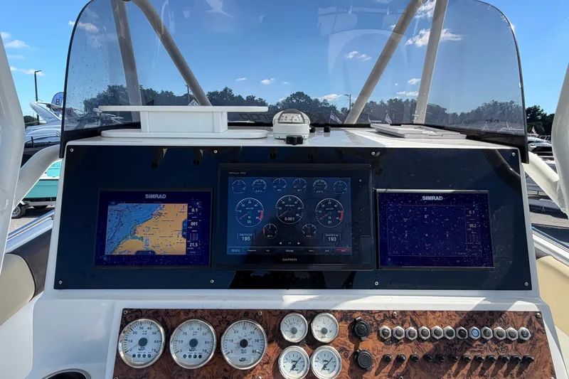 Slide: The Image of 2021 Key Largo 2650WI boat dashboard with navigation screens and gauges. - 31