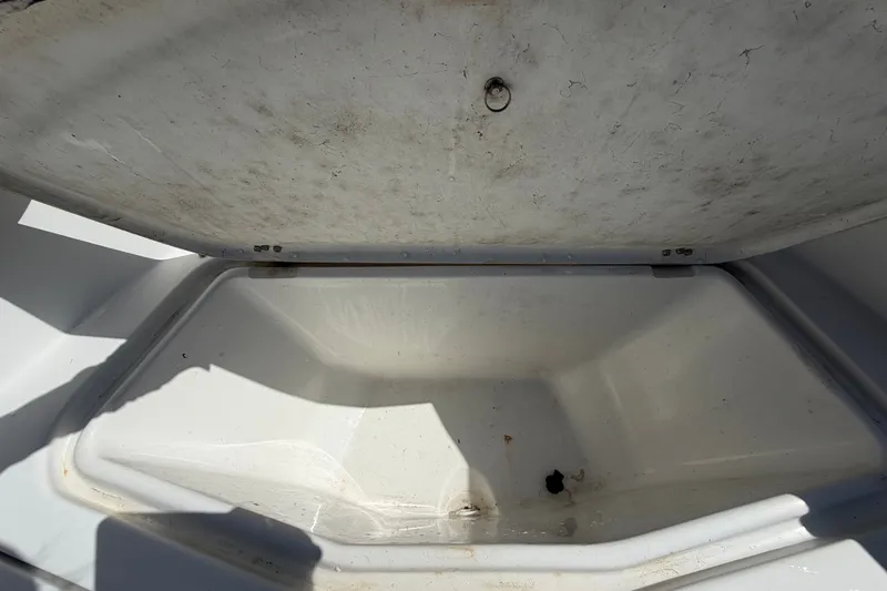 Slide: The Image of Open storage compartment on a 2021 Key Largo 2650WI boat, showing interior space. - 48