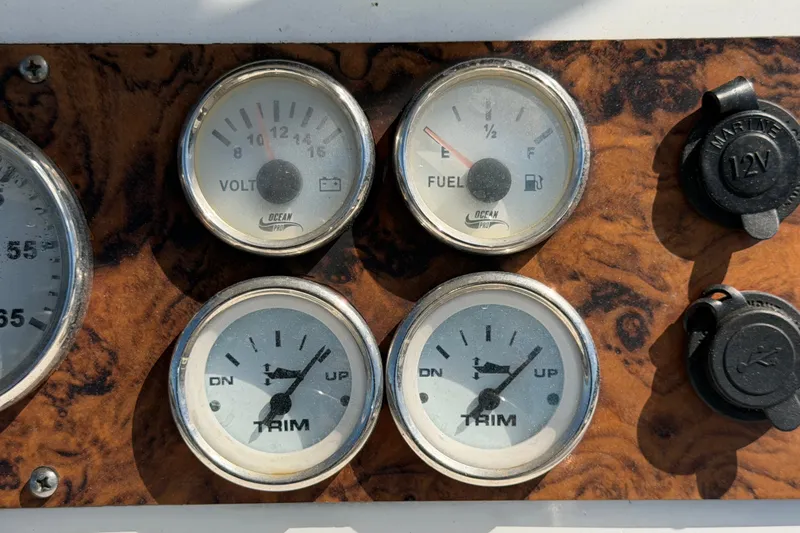 Slide: The Image of Instrument panel of a 2021 Key Largo 2650WI boat with gauges and 12V outlets. - 36