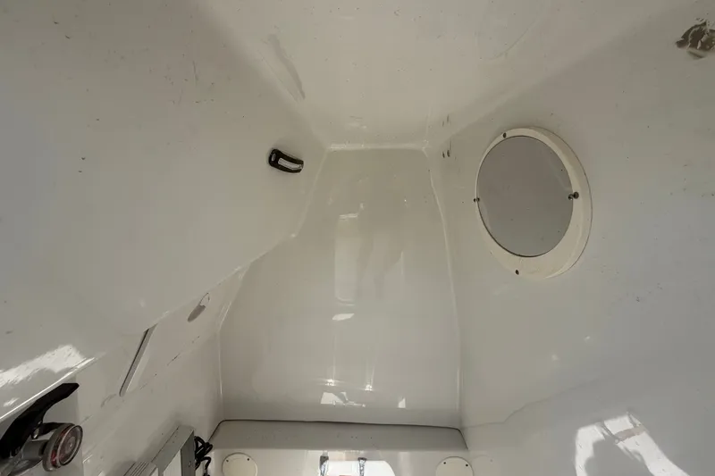 Slide: The Image of Interior view of 2021 Key Largo 2650WI boat cabin with porthole. - 64
