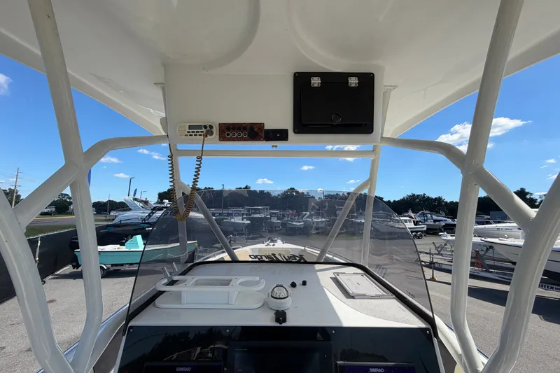 Slide: The Image of 2021 Key Largo 2650WI boat dashboard with marina view in background. - 25