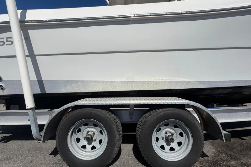Slide: The Image of 2021 Key Largo 2650WI boat on trailer, side view with dual wheels. - 86