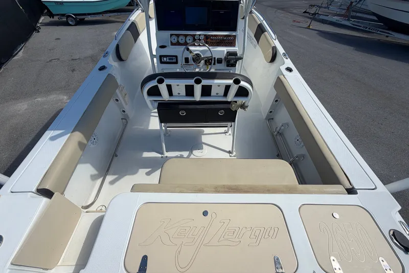 Slide: The Image of 2021 Key Largo 2650WI boat interior with steering console and seating. - 19