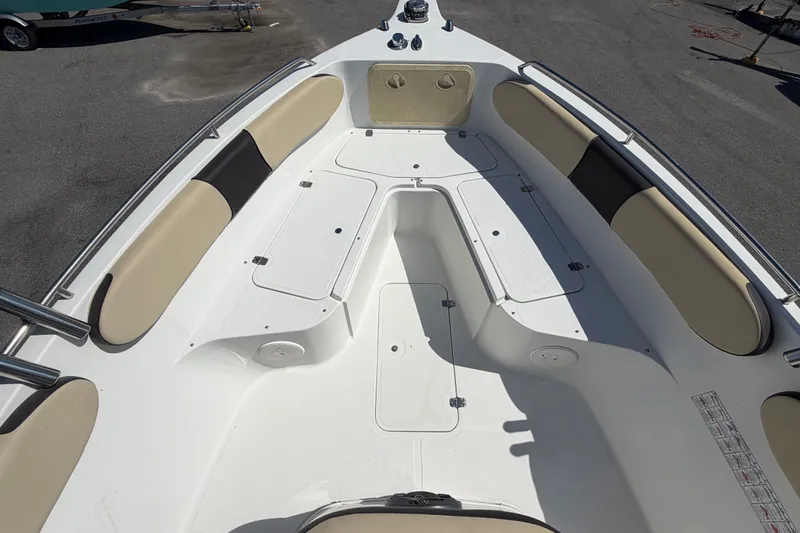 Slide: The Image of 2021 Key Largo 2650WI boat interior with spacious seating and storage compartments. - 42