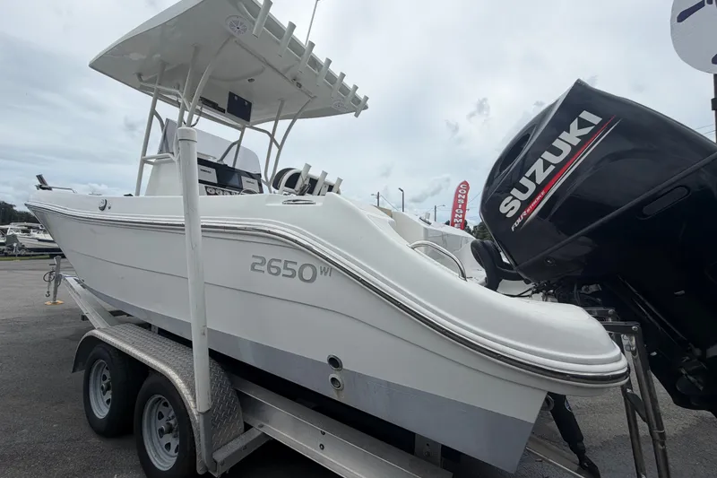 Slide: The Image of 2021 Key Largo 2650WI boat on trailer with Suzuki outboard motor. - 4
