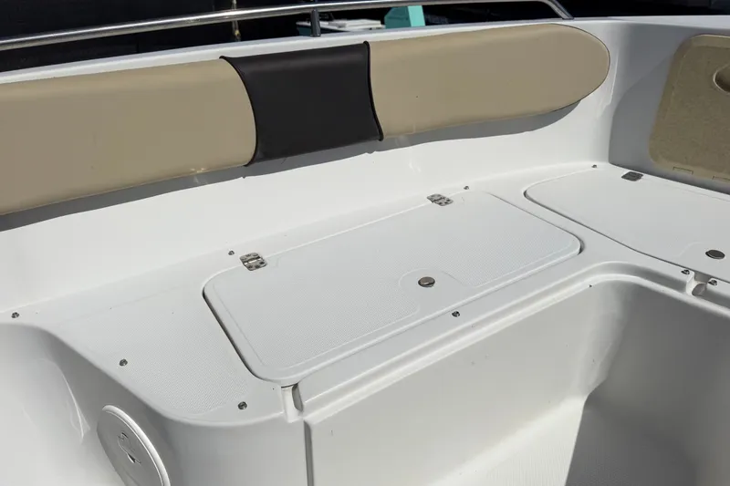 Slide: The Image of 2021 Key Largo 2650WI boat interior with storage compartments and cushioned seating. - 46