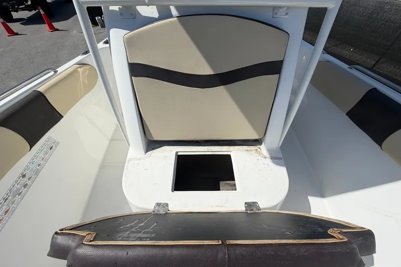 Slide: The Image of 2021 Key Largo 2650WI boat interior with seating and storage compartment. - 59