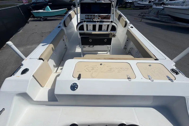 Slide: The Image of 2021 Key Largo 2650WI boat interior with seating and control panel. - 18