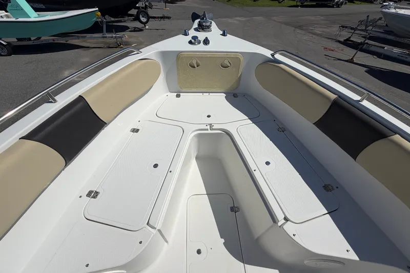 Slide: The Image of 2021 Key Largo 2650WI boat interior with cushioned seating and storage compartments. - 45