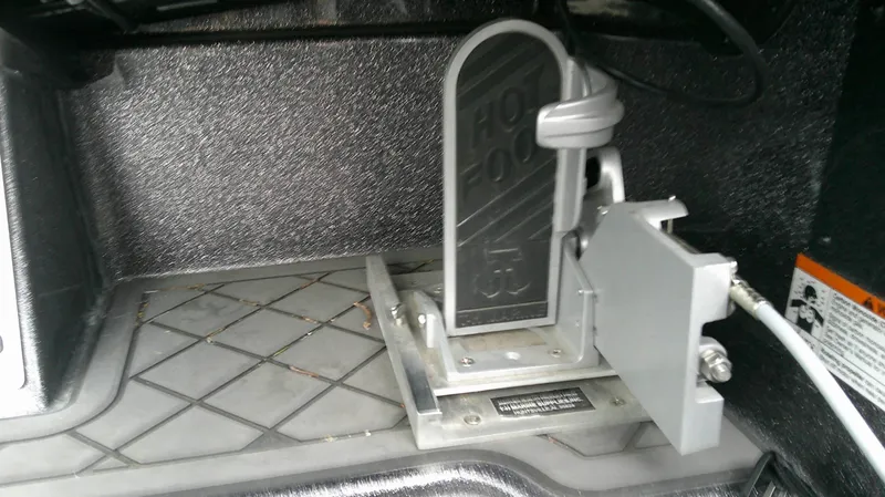 Slide: The Image of Close-up of a boat pedal labeled "Hot Foot" in the cockpit area. - 11