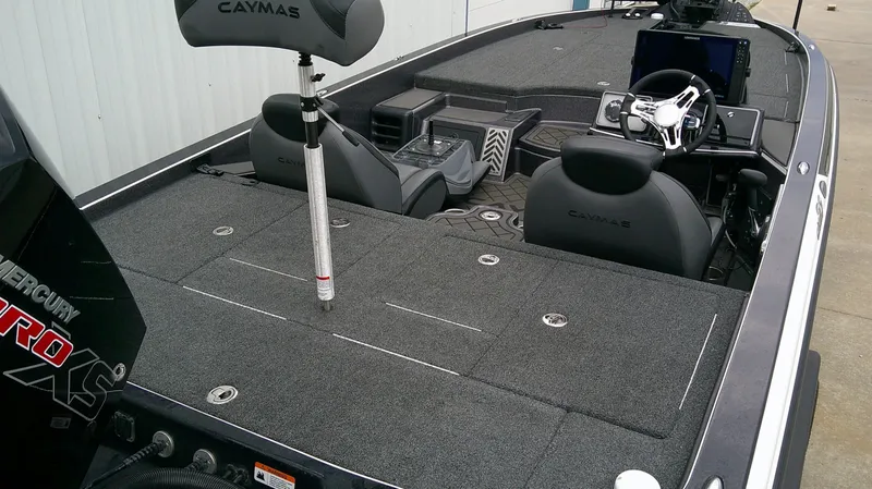 Slide: The Image of The image shows the cockpit of a 2025 Caymas CX 21 PRO boat with gray seats and a modern helm. - 7