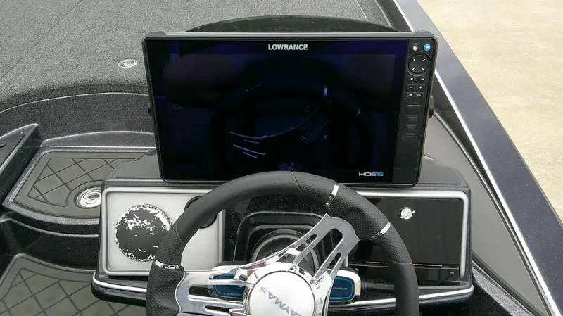 Slide: The Image of The image shows the cockpit of a Caymas CX 21 PRO boat with a large Lowrance screen and modern steering wheel. - 9