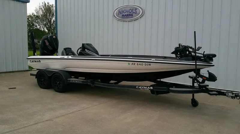Slide: The Image of A 2025 Caymas CX 21 PRO boat on a trailer in front of a building. - 4