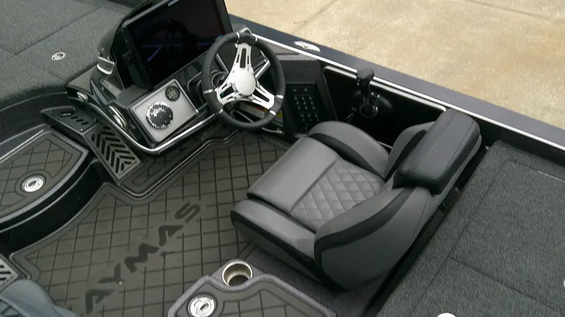 Slide: The Image of The image shows the cockpit of a 2025 Caymas CX 21 PRO boat with a sleek steering wheel and cushioned seat. - 8