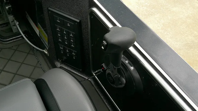 Slide: The Image of Close-up of the throttle and control panel in a Caymas CX 21 PRO boat. - 10