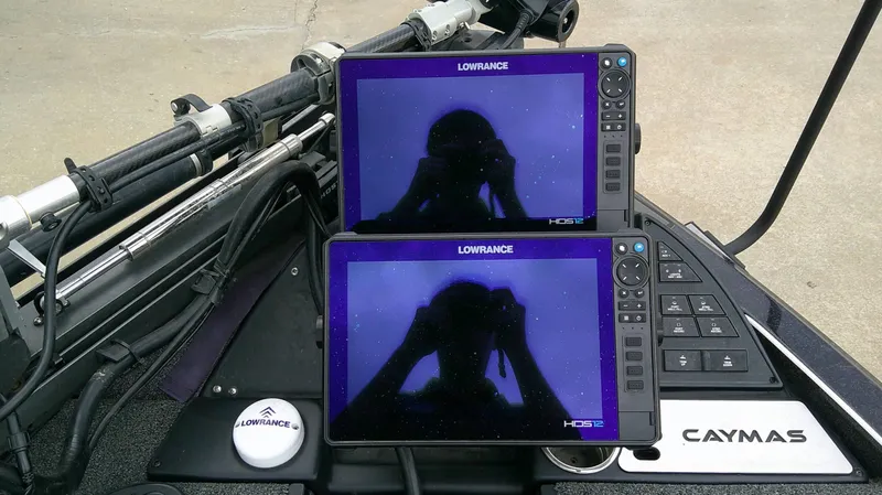 Slide: The Image of Two Lowrance screens are mounted on a Caymas CX 21 PRO boat. - 12