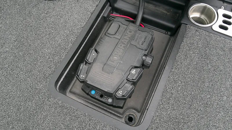 Slide: The Image of A Lowrance device is installed in a compartment with gray carpeting. - 13