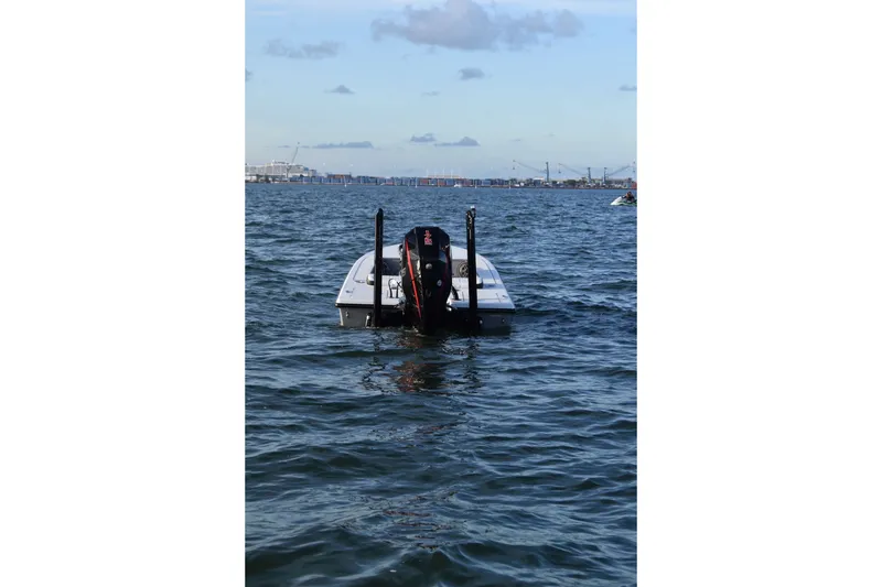 Slide: The Image of 2021 V-Tech 18 Flats boat on open water with distant city skyline. - 5