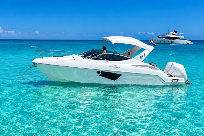 The Image of 2023 Schaefer 303 Sport yacht on clear turquoise water, sunny day. - 0