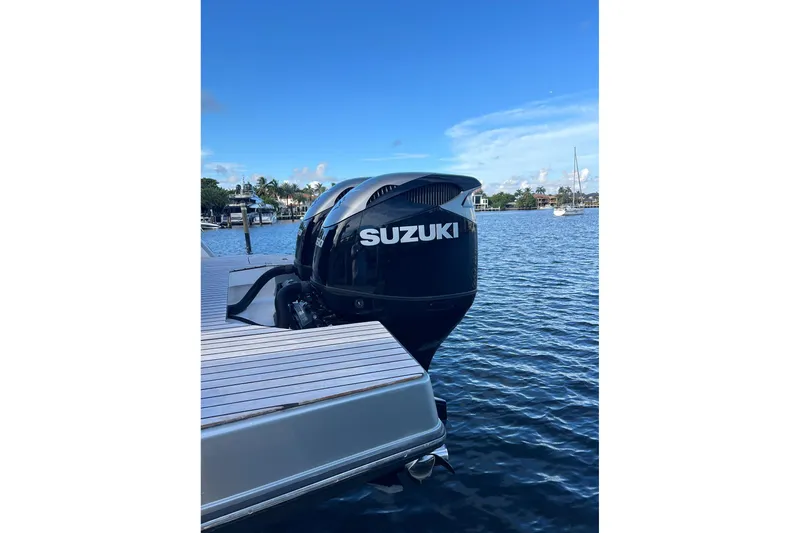Slide: The Image of 2023 Schaefer V33 boat with Suzuki outboard motor on a calm waterfront. - 20
