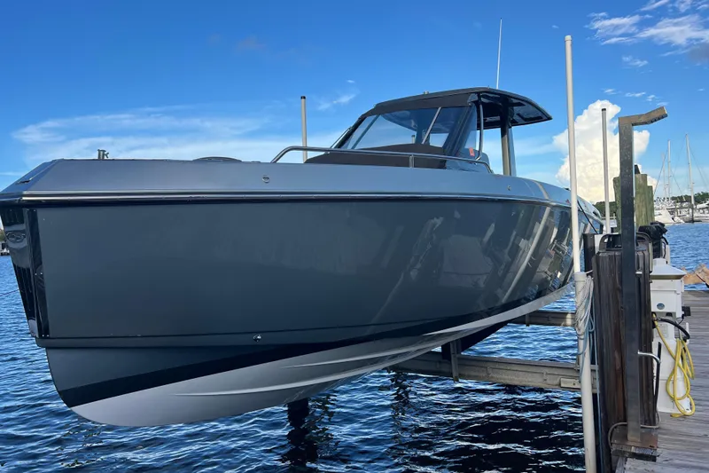The Image of 2023 Schaefer V33 boat docked, sleek design against a clear blue sky. - 1