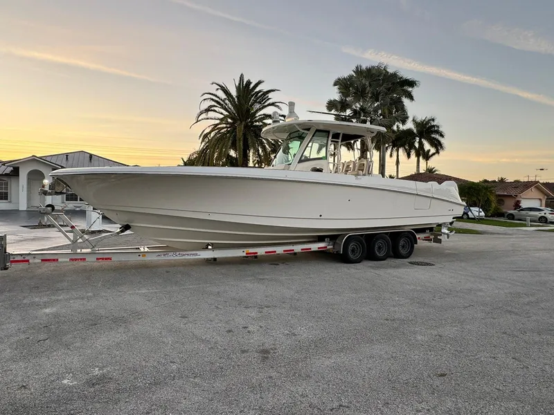 Slide: The Image of 2021 Boston Whaler 350 Outrage boat on a trailer at sunset. - 3
