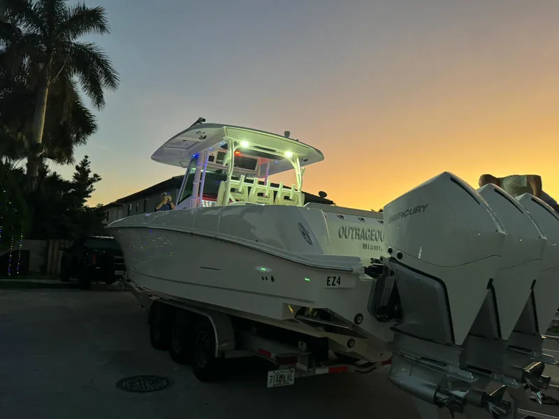 Slide: The Image of 2021 Boston Whaler 350 Outrage boat on trailer at sunset. - 15
