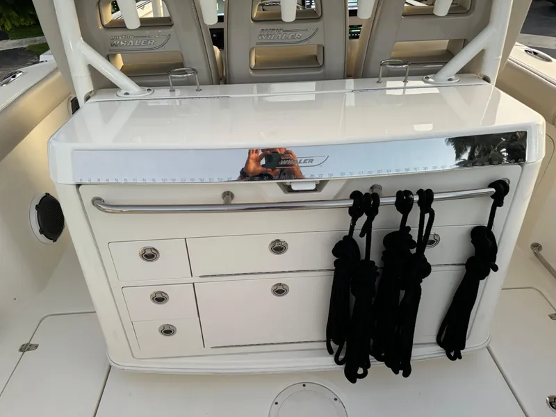 Slide: The Image of 2021 Boston Whaler 350 Outrage boat interior with storage drawers and rope holders. - 48