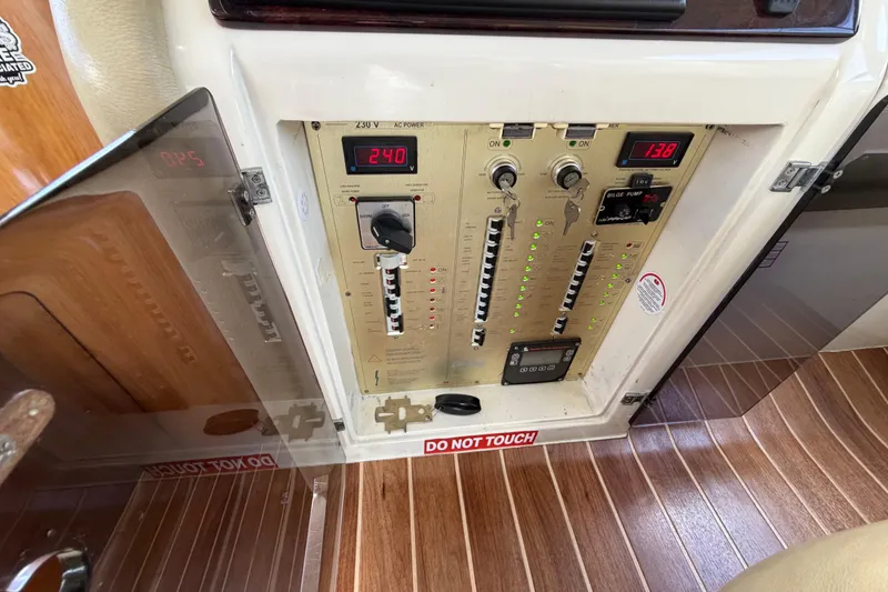 Slide: The Image of Electrical control panel on 2007 Cranchi Atlantique 40 yacht, displaying voltage and switches. - 18