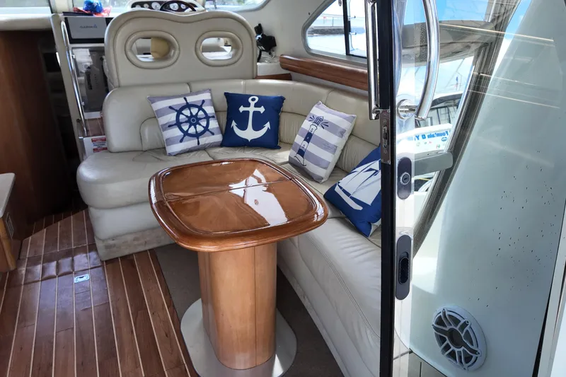 Slide: The Image of Interior of 2007 Cranchi Atlantique 40 yacht with nautical-themed cushions and wooden table. - 11