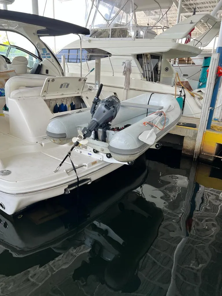 Slide: The Image of 2007 Sea Ray 44 Sundancer with inflatable dinghy and outboard motor at marina. - 17