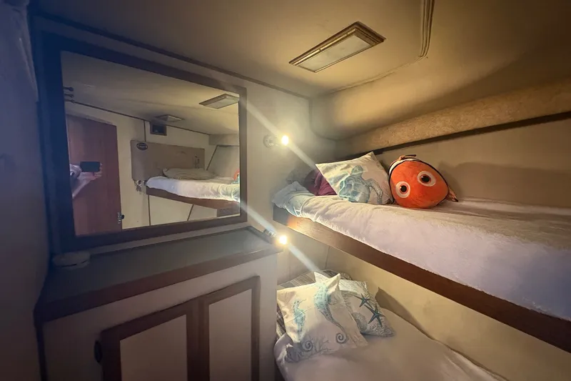 Slide: The Image of Cozy cabin interior of 1989 Topaz 44 Sportfisherman with bunk beds and plush toy. - 15