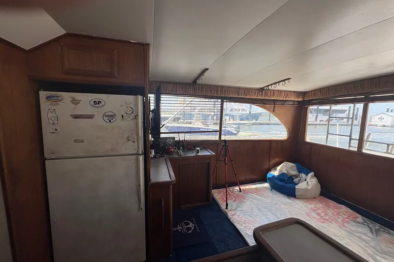 Slide: The Image of Interior of 1989 Topaz 44 Sportfisherman with fridge, windows, and nautical decor. - 9