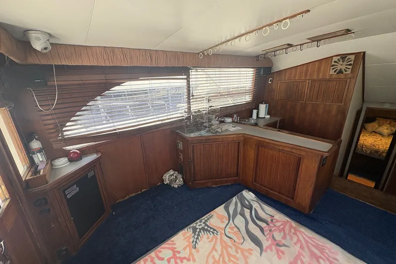 Slide: The Image of Interior of 1989 Topaz 44 Sportfisherman yacht with wooden cabinetry and blue carpet. - 8