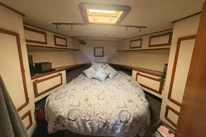Slide: The Image of Cozy cabin interior of 1989 Topaz 44 Sportfisherman with nautical-themed bedding. - 17