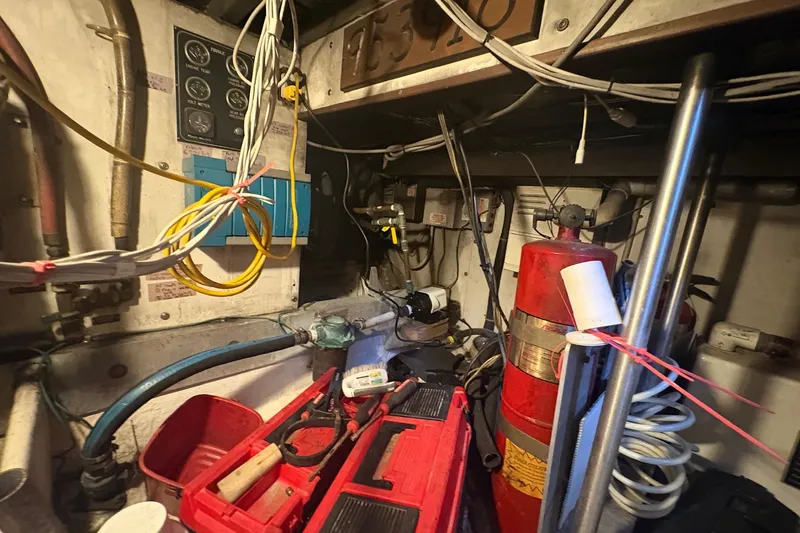 Slide: The Image of Engine room of a 1989 Topaz 44 Sportfisherman with tools and equipment. - 29