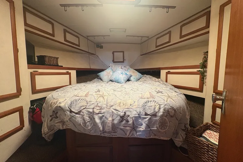 Slide: The Image of Cozy cabin interior of 1989 Topaz 44 Sportfisherman with nautical-themed bedding. - 16