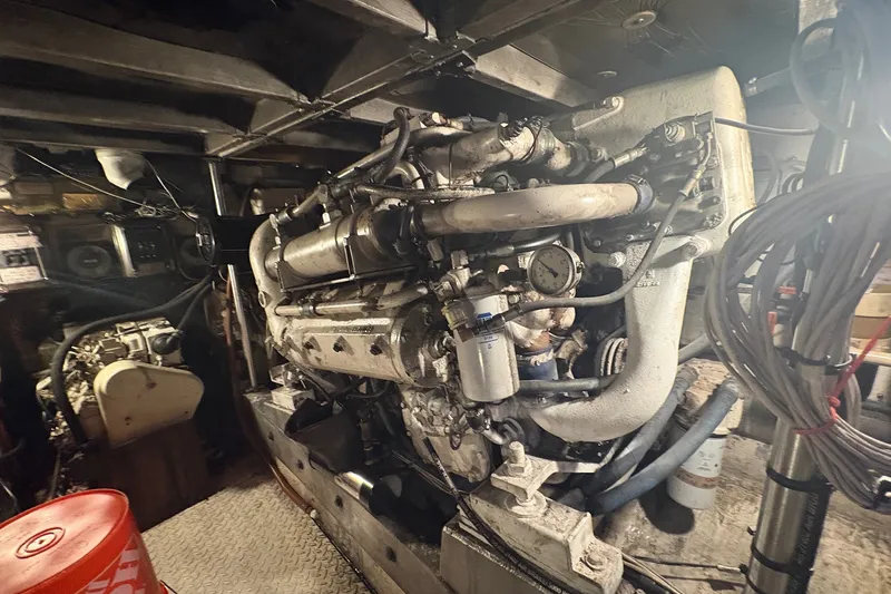 Slide: The Image of Engine room of a 1989 Topaz 44 Sportfisherman boat, showcasing detailed machinery. - 26
