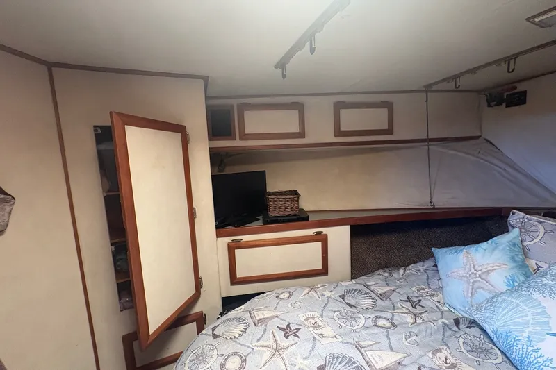 Slide: The Image of Cozy cabin interior of 1989 Topaz 44 Sportfisherman with nautical-themed bedding. - 19
