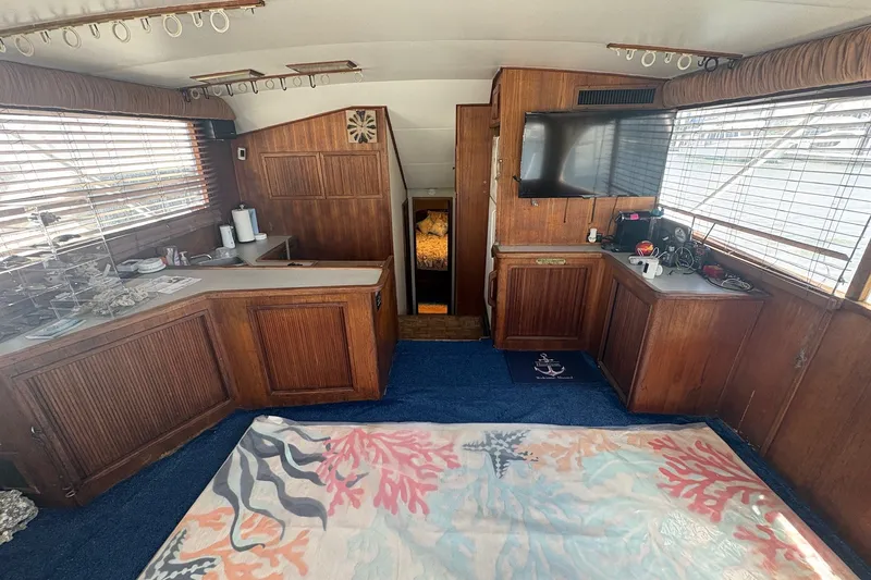 Slide: The Image of Interior of 1989 Topaz 44 Sportfisherman with wooden cabinetry and nautical decor. - 6